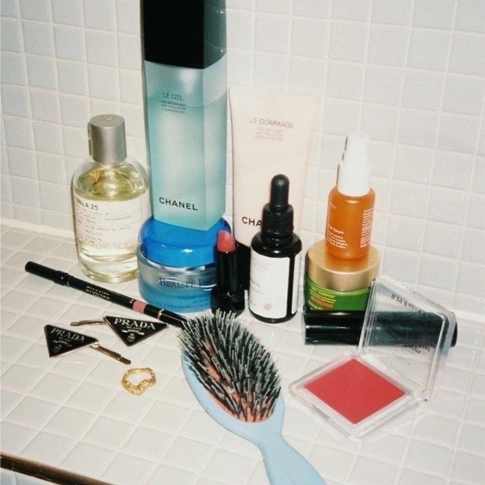 Beauty products on a tiled bathroom counter