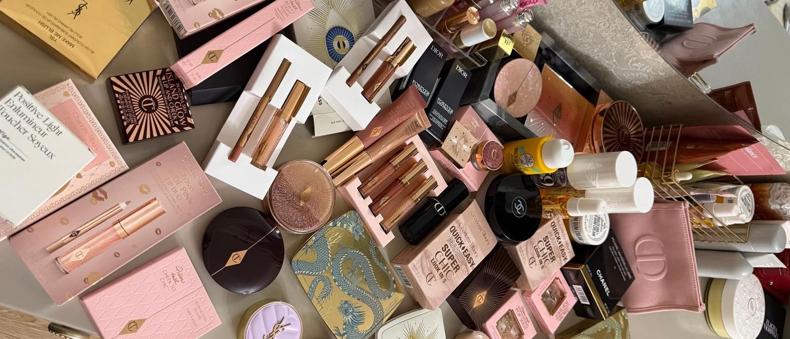 A dressing table covered in unused beauty products